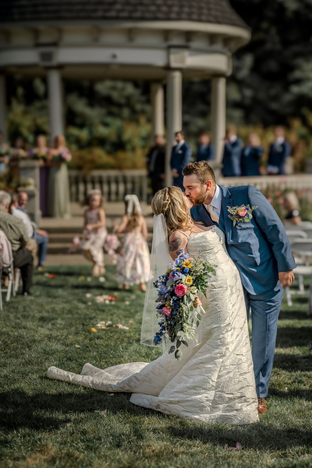 Wedding ceremony in a garden gazebo with bride in lace dress holding colorful bouquet. Pittsburgh Wedding Photography, Videography