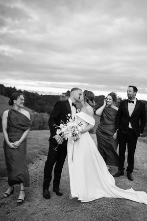Black and white photo series of wedding party celebrating outdoors.