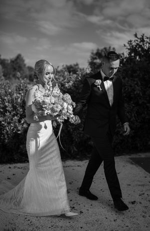 A dramatic black and white wedding photo sequence showing a couple dancing outdoors.