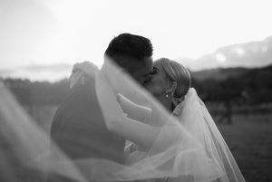 Artistic silhouette shots of a wedding couple embracing during sunset.