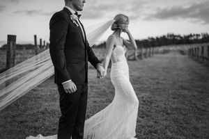 Black and white wedding portraits showing romantic moments on a cloudy day.