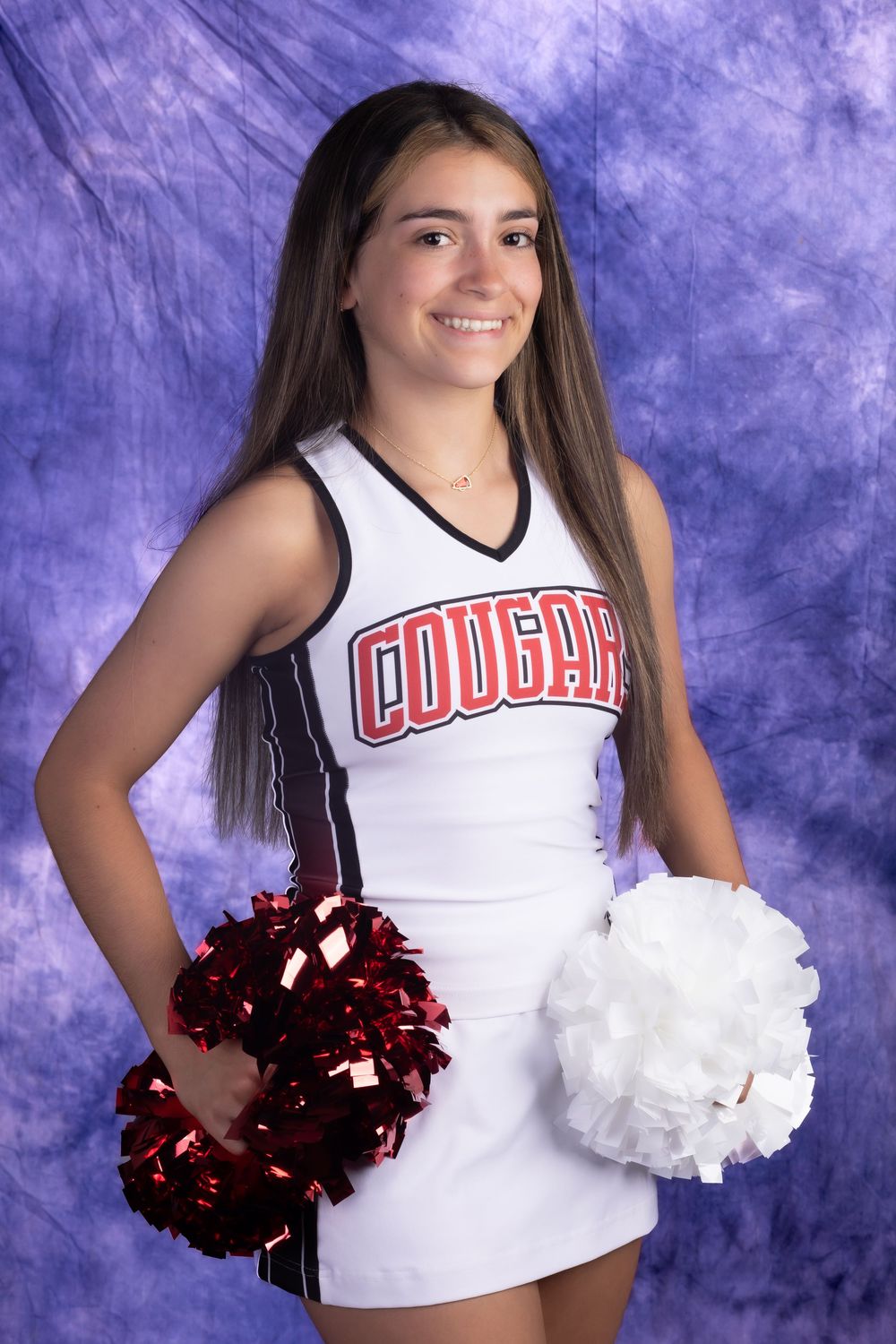 A smiling teenage cheerleader in a white Cougars uniform holds red and white pom-poms against a purple backdrop.