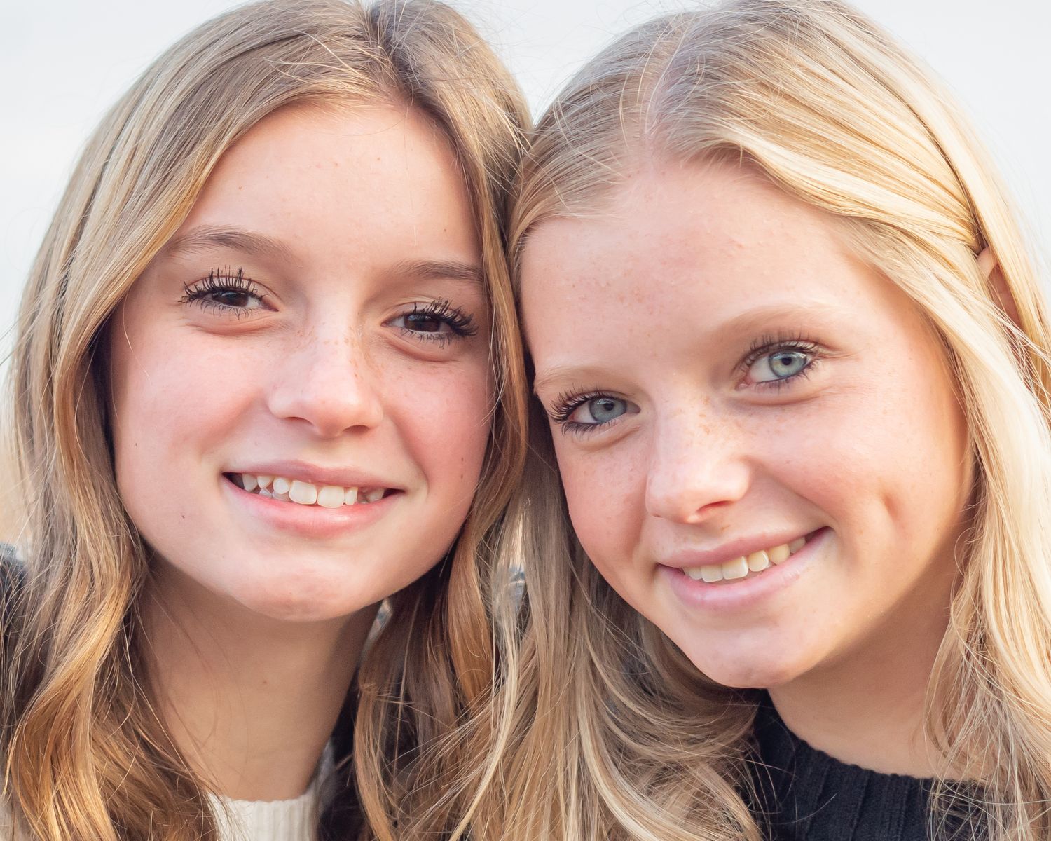 A series of close-up headshots with warm lighting against a white background.