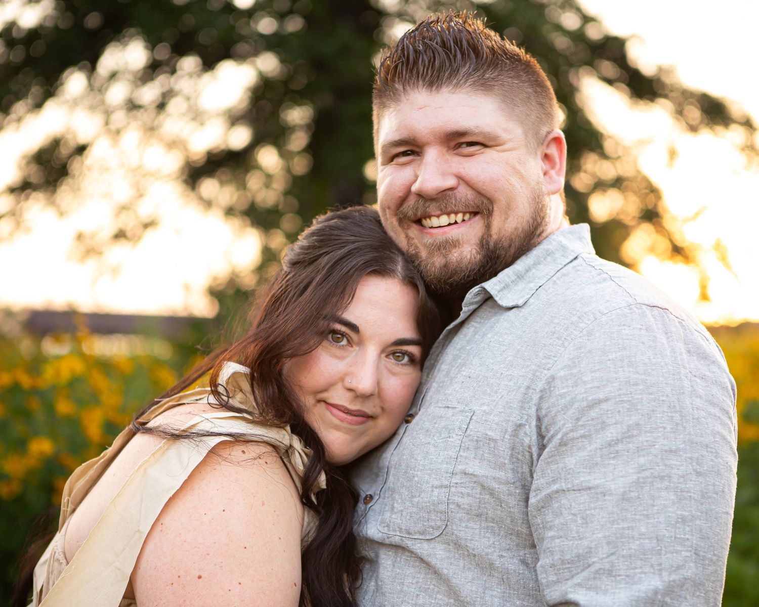 Romantic outdoor portrait session in warm evening light with sunflowers.
