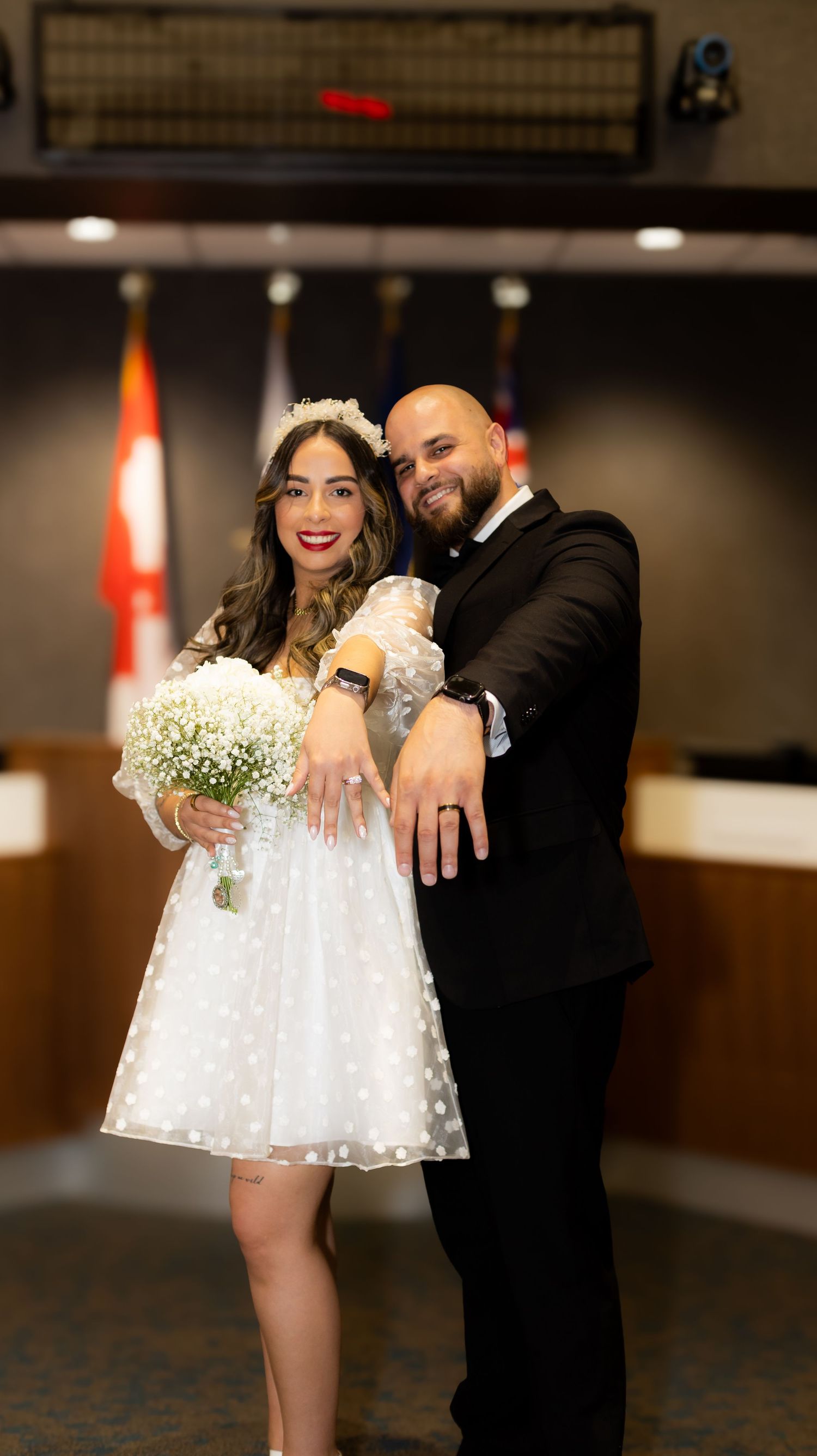 Indoor celebration with couple in white dress and black suit.