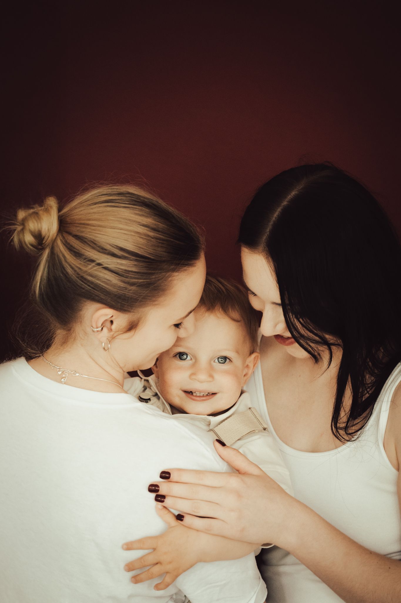 Tender moment between parent and child in warm, intimate setting with bokeh lights.