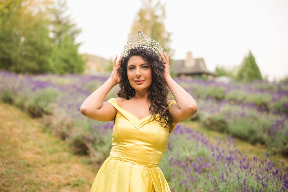 An Indian beauty queen wears her crown proudly outside in a field of lavender.