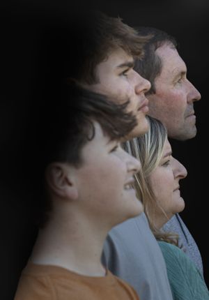 Artistic side profile portrait showing multiple faces against dark background.