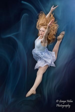 Dynamic dance photography sequence with flowing blue background and ethereal movement.