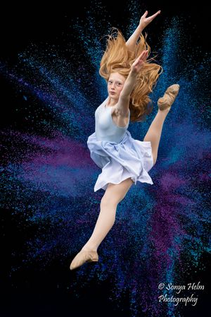 Ethereal dance leaps against a starry blue and purple background showing graceful movement.