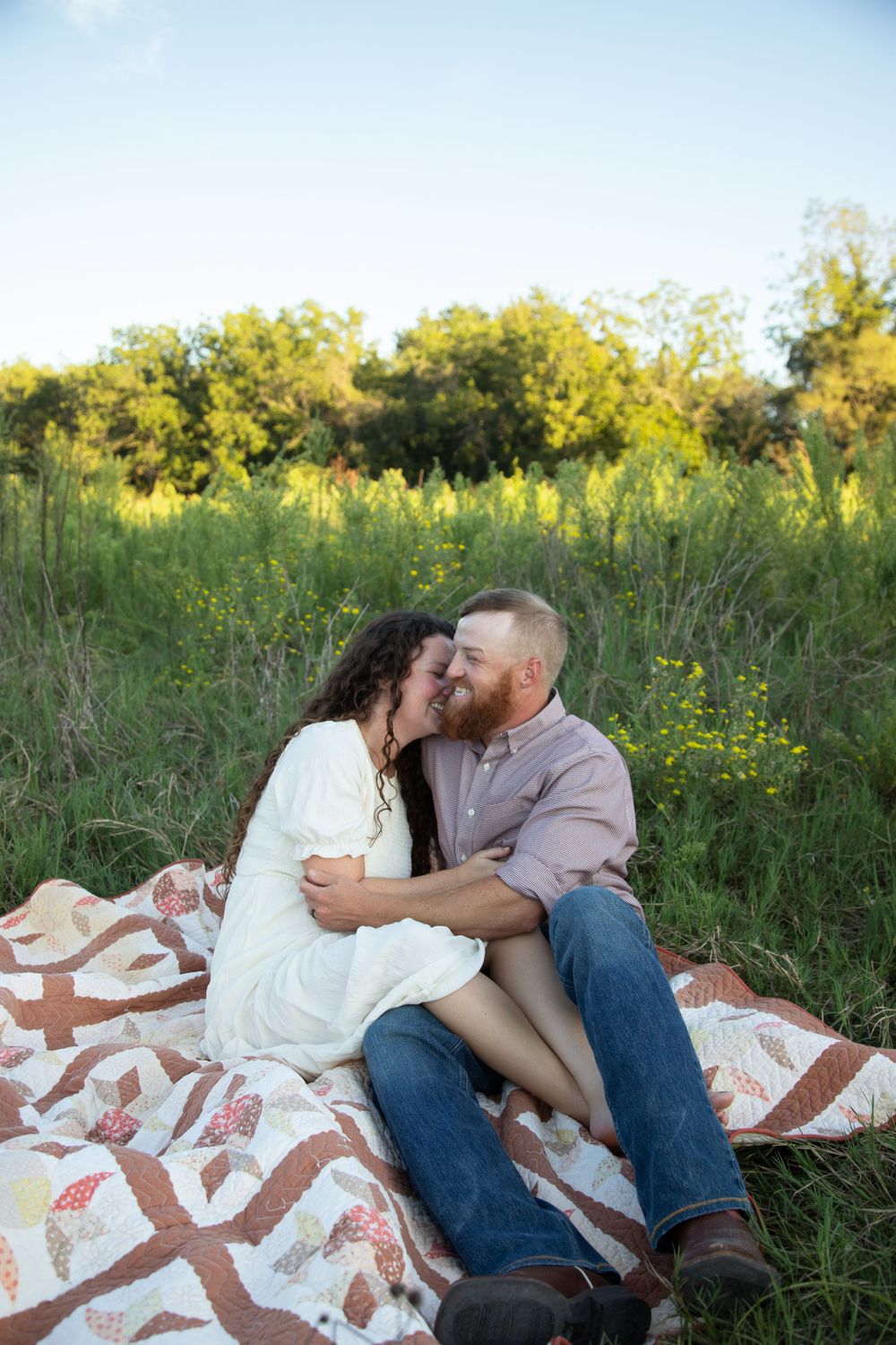 Couple Hugging on quilt in Stephenville, Wildflower couples photo,  Stephenville Couples Photographer, Erath County Couples Photographer,