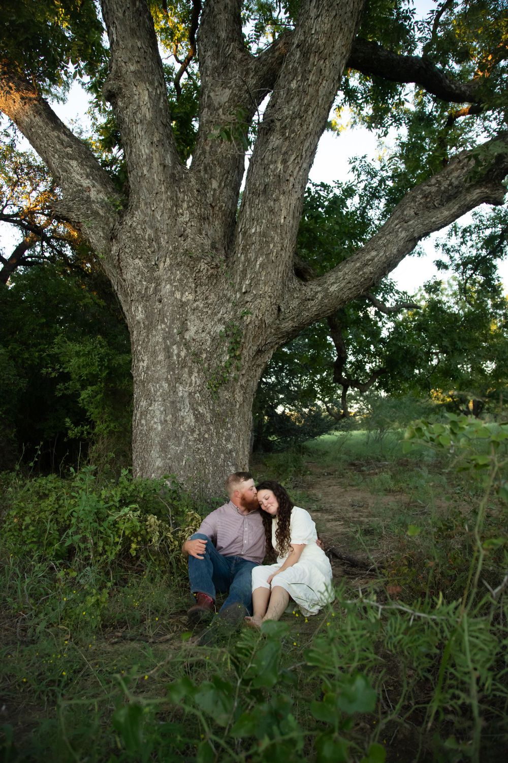 Couple sitting by tree in Stephenville, Wildflower couples photo,  Stephenville Couples Photographer, Erath County Couples Photographer,