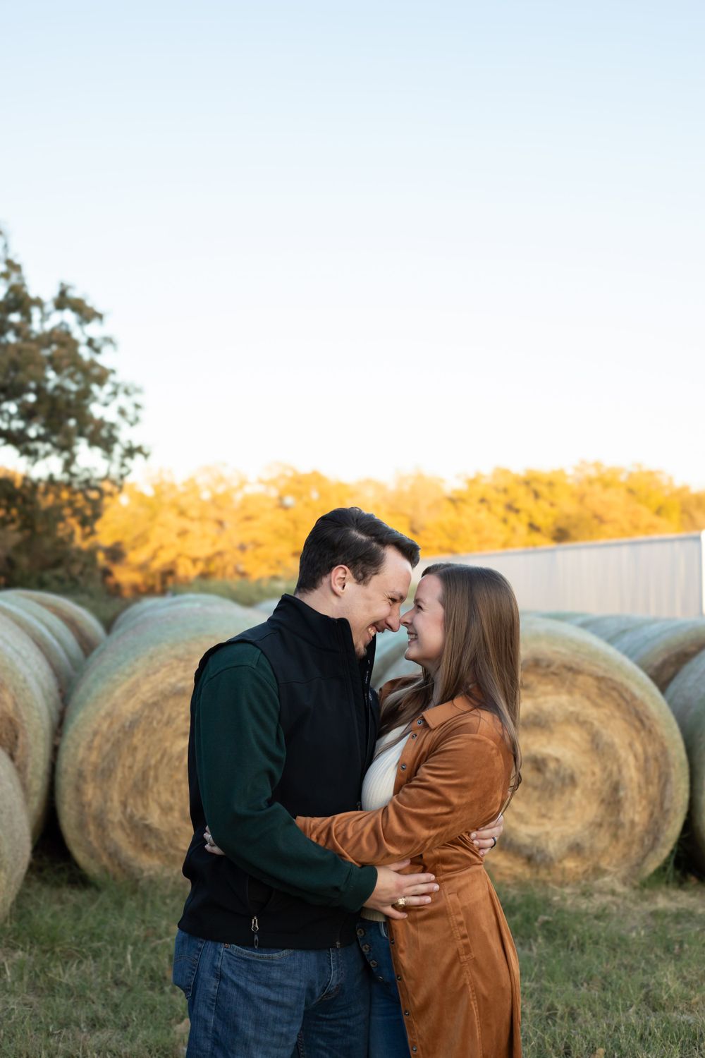Couple Hugging by hay bales in Stephenville,  Stephenville Couples Photographer, Erath County Couples Photographer,