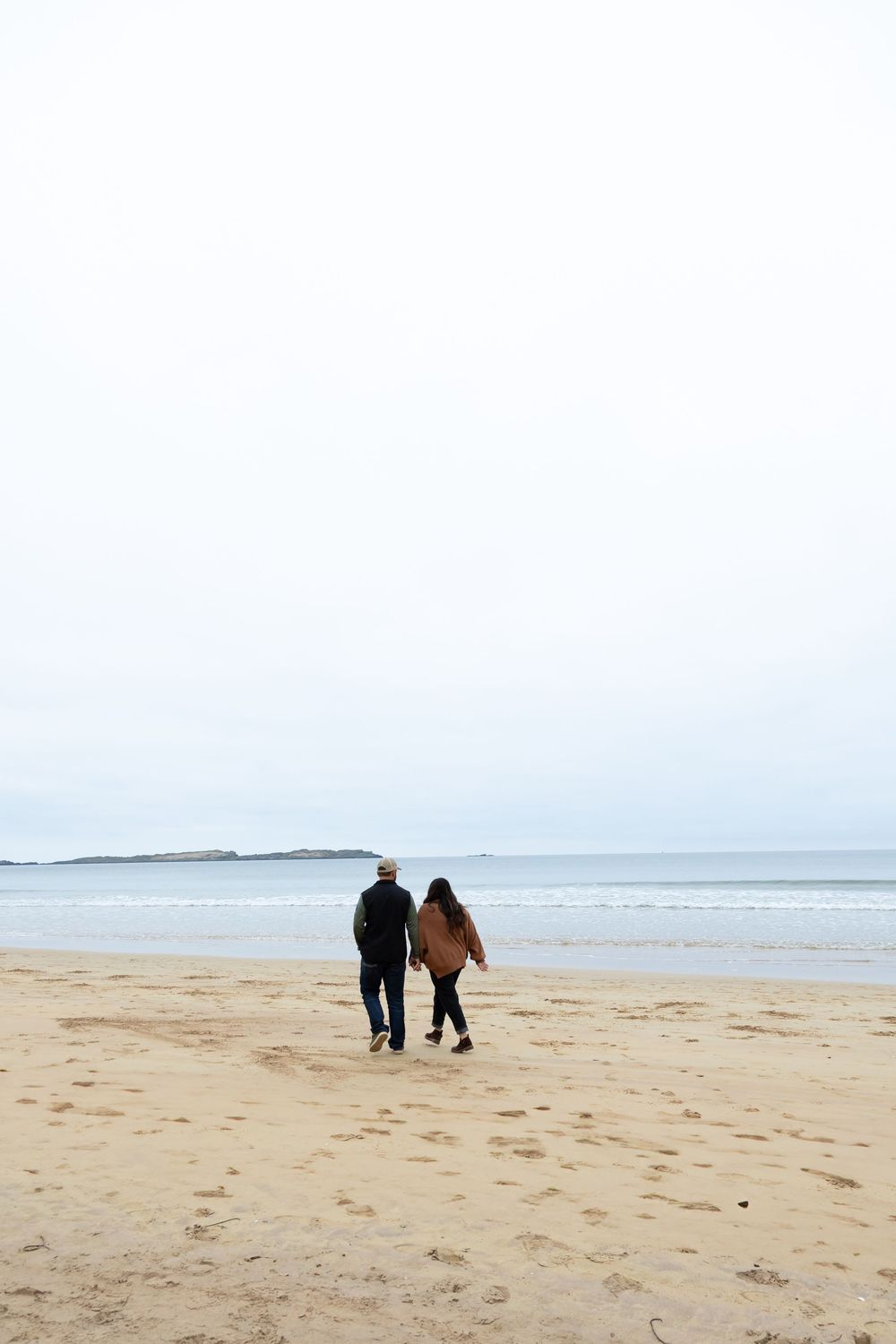 couple holding hands on beach in texas, texas beach photographer