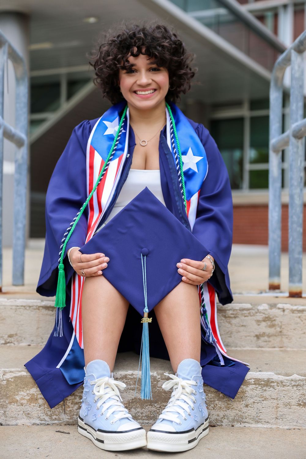 Low angle view of sneakers and graduation regalia with American flag-themed decorations.