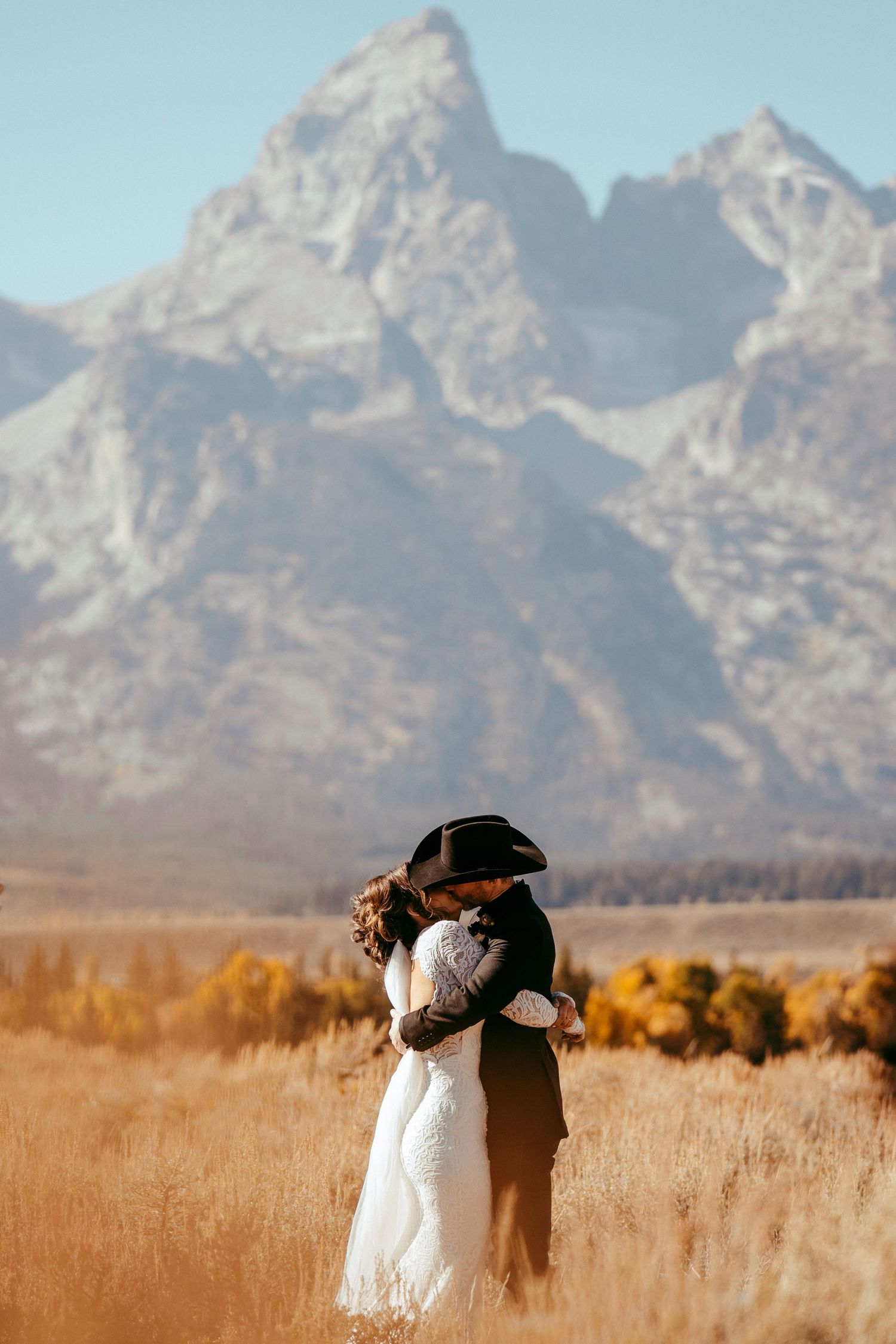 Golden hour sunlight creates a warm glow over the scenic mountain backdrop