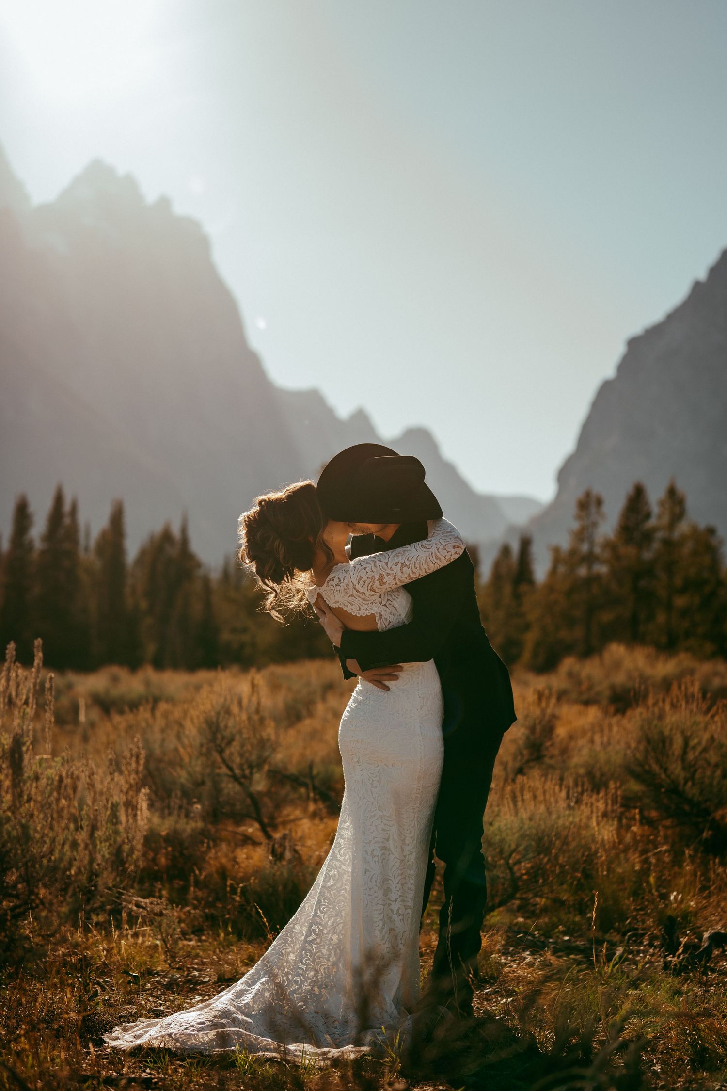Golden hour sunlight creates a warm glow over the scenic mountain backdrop