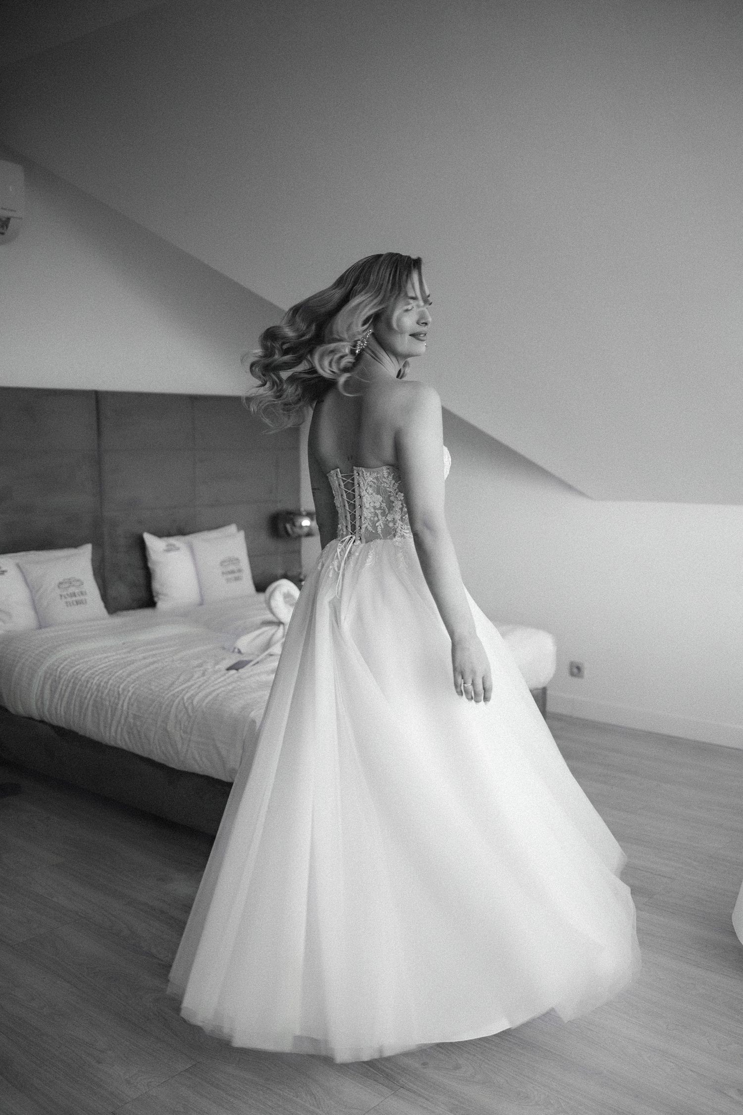 Black and white portrait showing elegant wedding dress with sweetheart neckline and full tulle skirt.