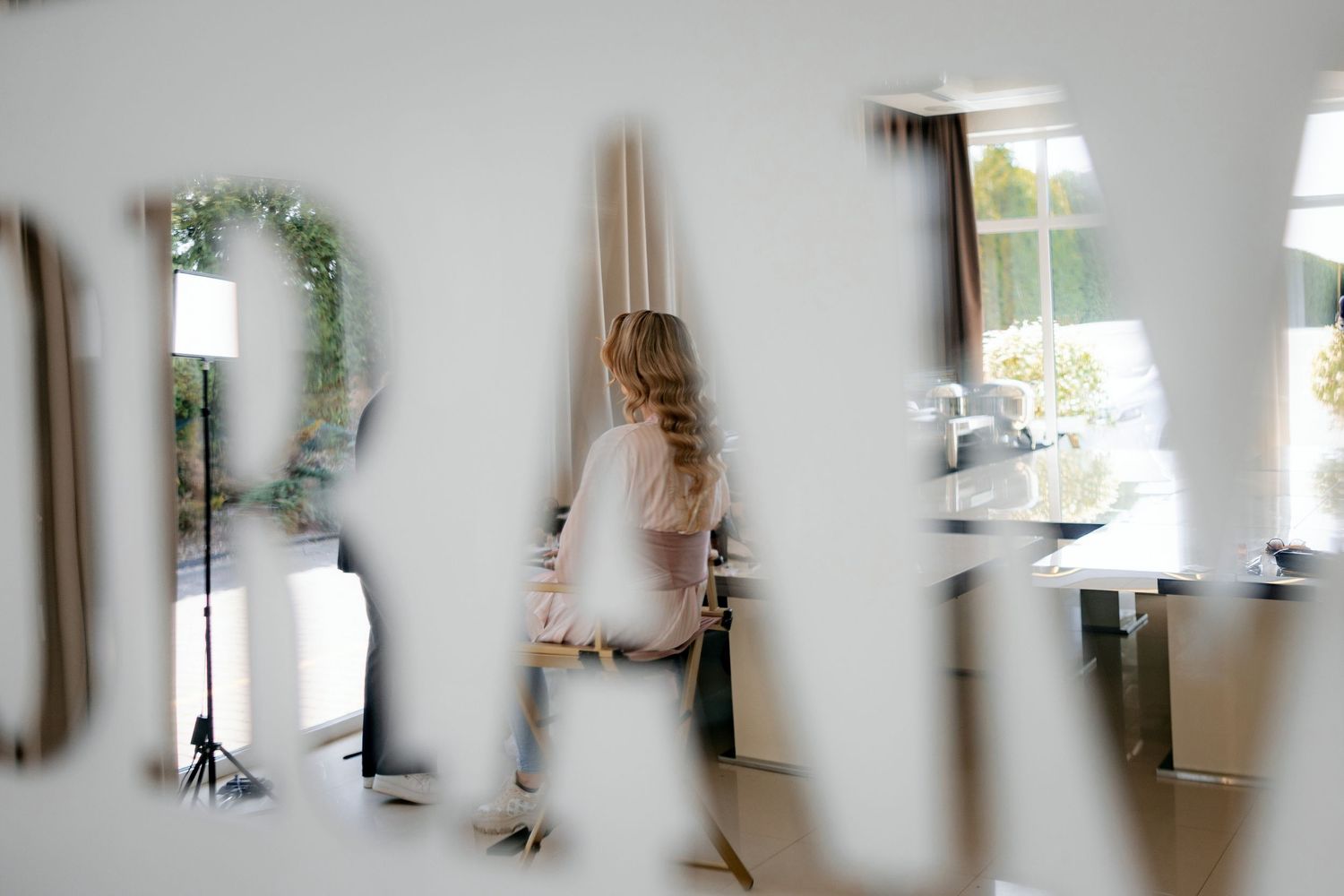 An artistic blurred reflection of wedding preparations in a mirror.