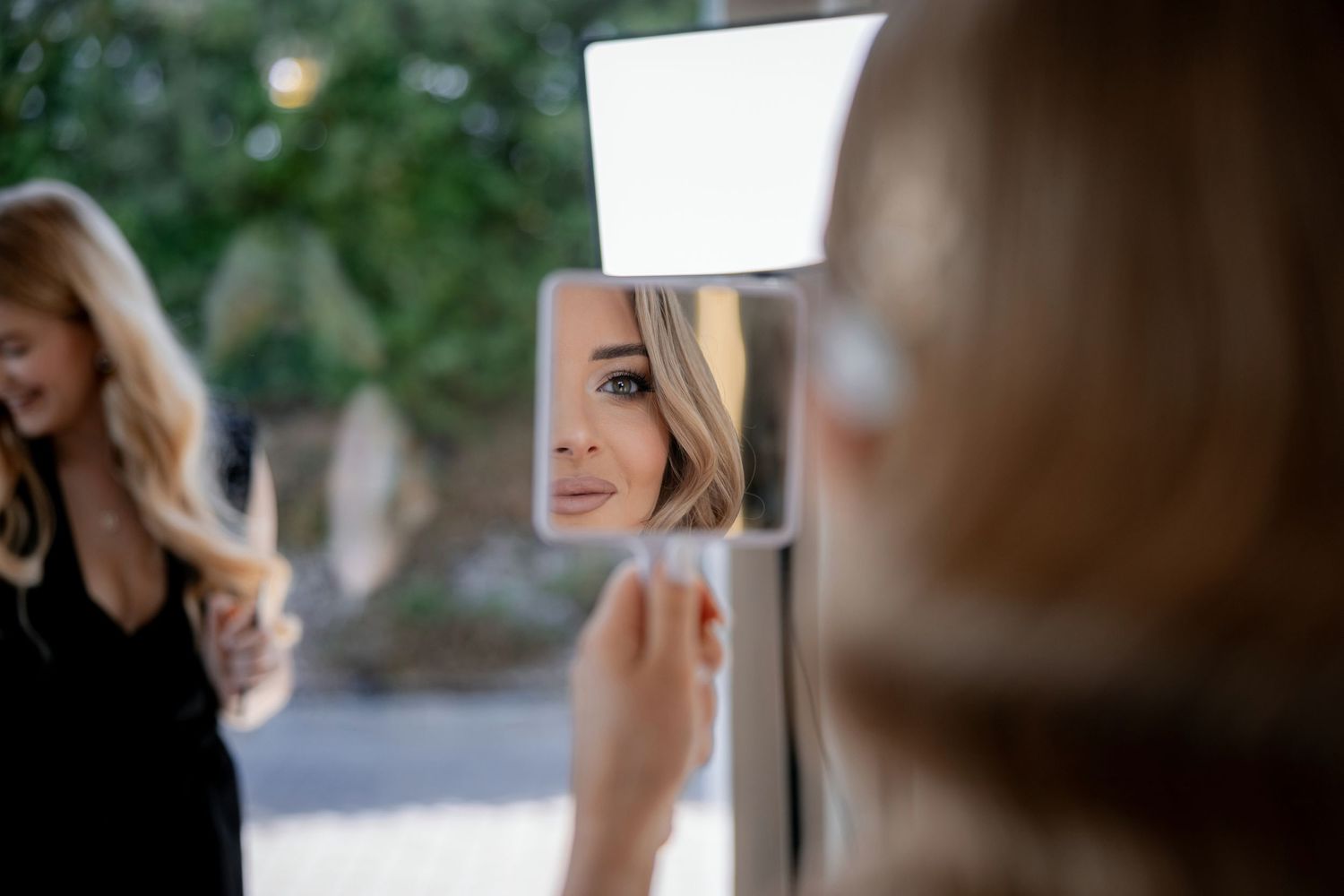 A blurred behind-the-scenes moment of wedding preparations with a mirror reflection.