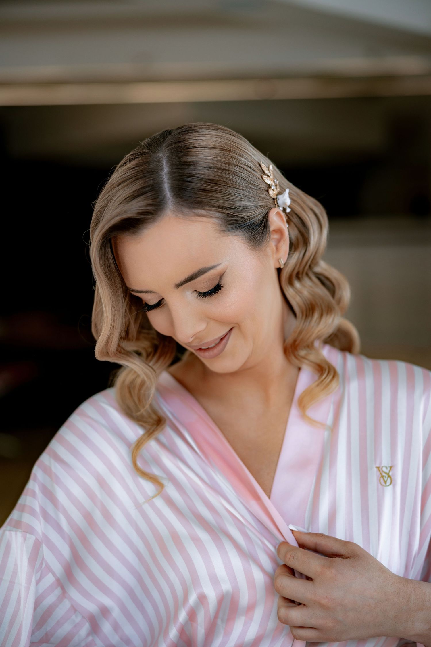 Elegant wedding preparation scene with soft waves and delicate hair accessories.
