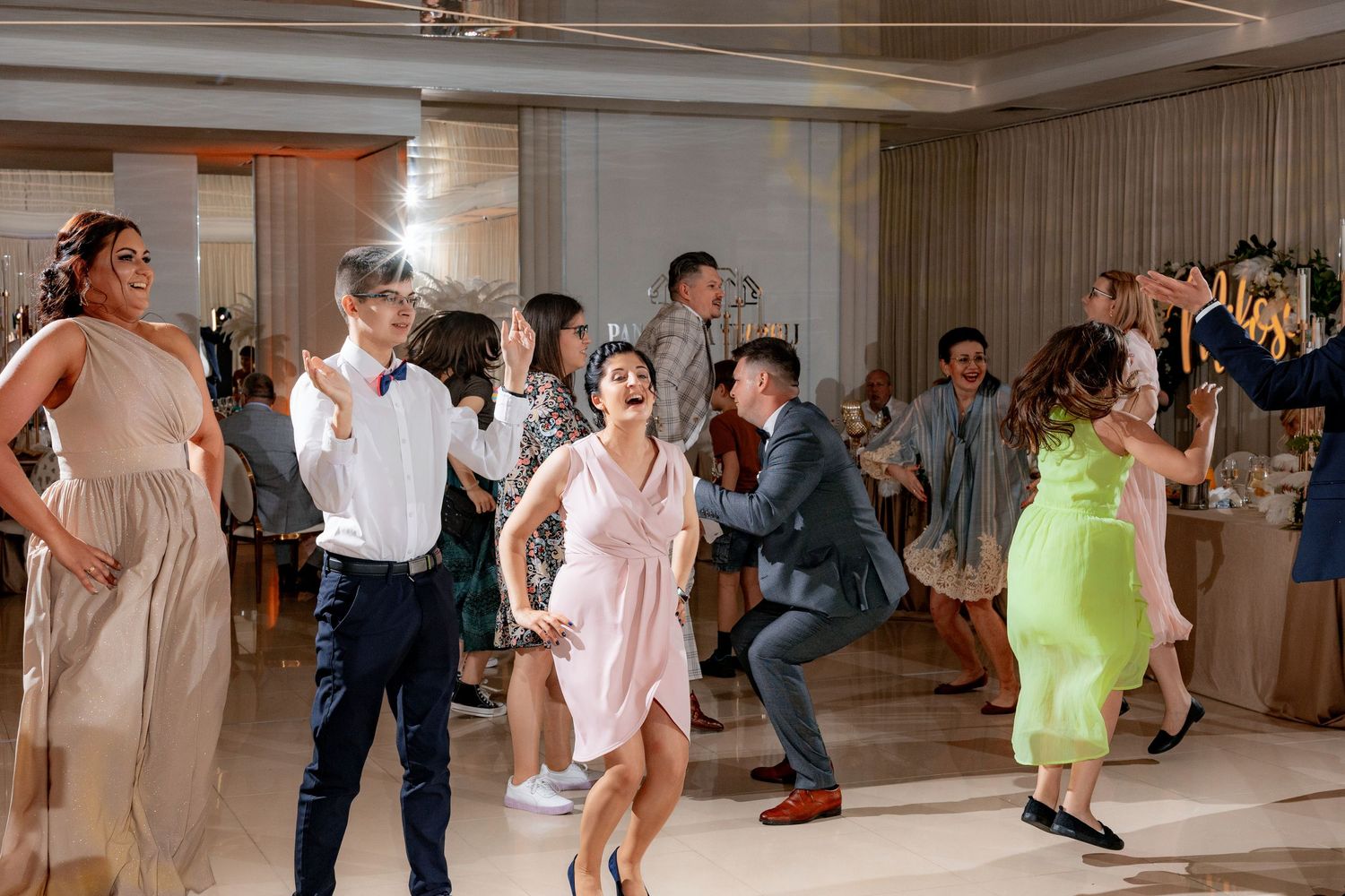 Wedding reception dance party with guests enjoying themselves on the dance floor.