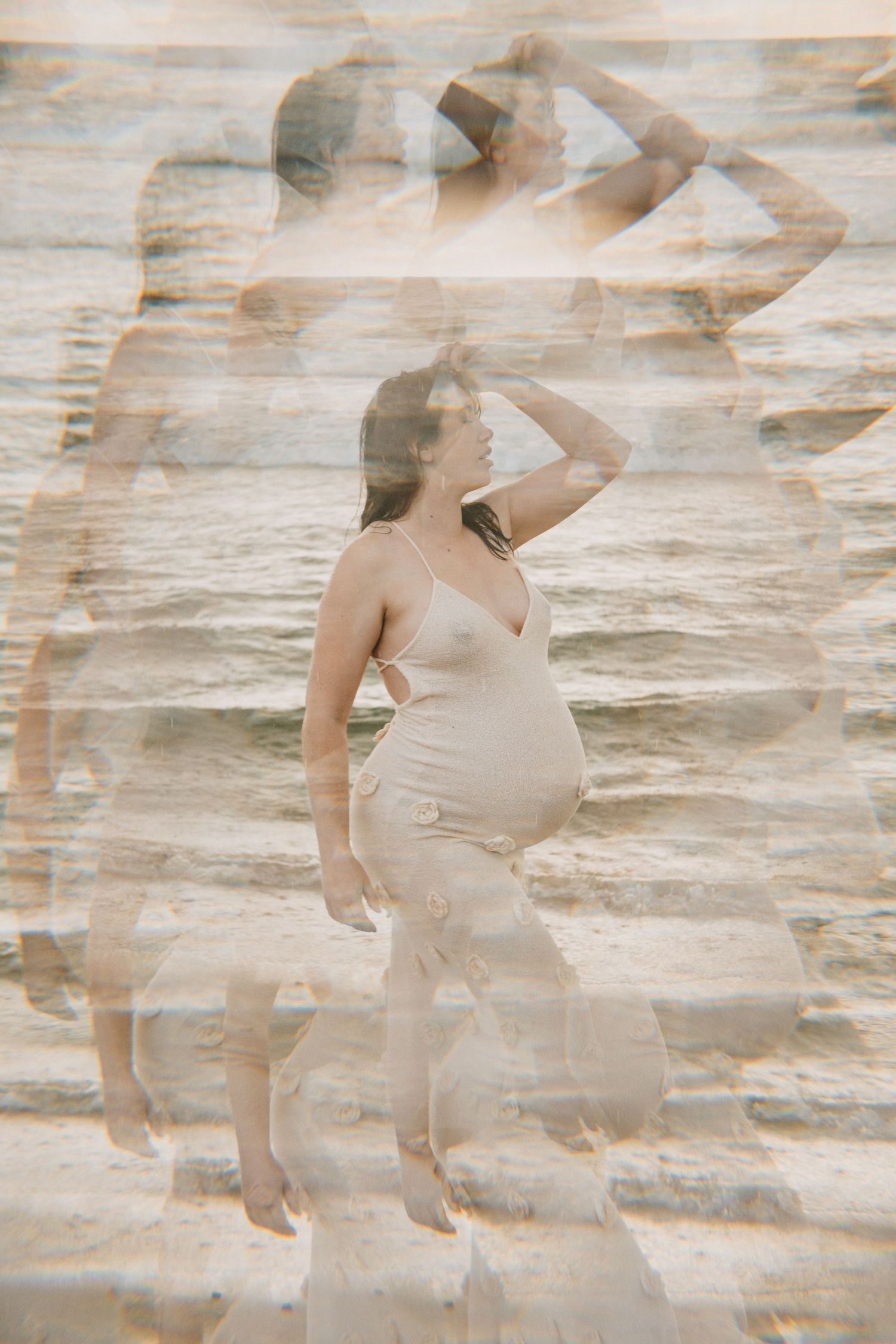 Artistic double exposure maternity photo with silhouette against water backdrop.