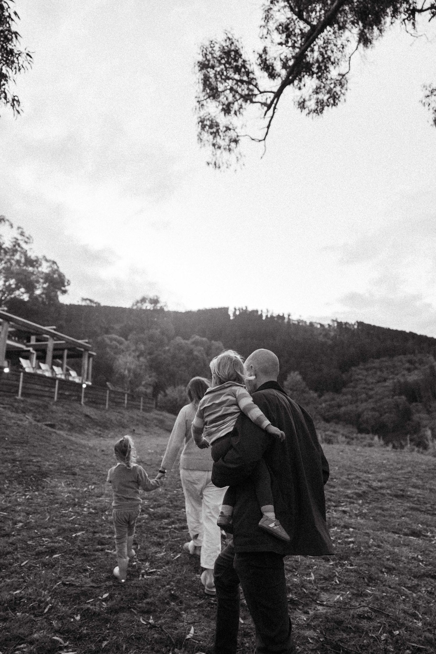 A family of four walking through their farm and life together. A perfect family photo that makes you feel the moment.