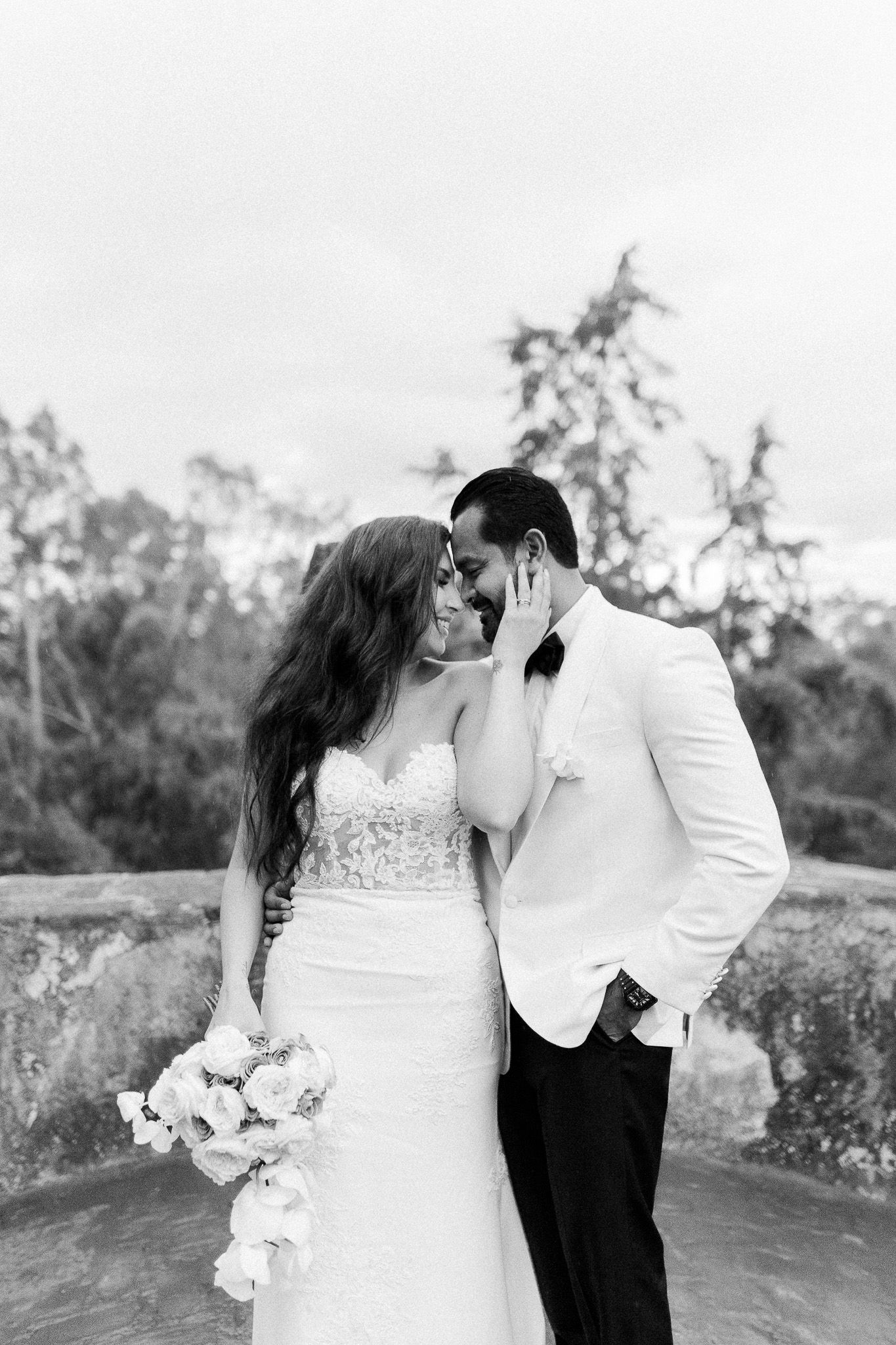 Black and white romantic wedding portrait in natural outdoor setting.