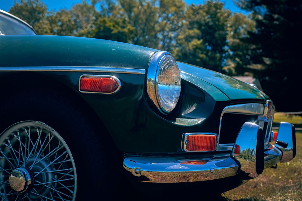 Detail shots of a vintage Jaguar E-Type showing elegant curves and chrome trim details.
