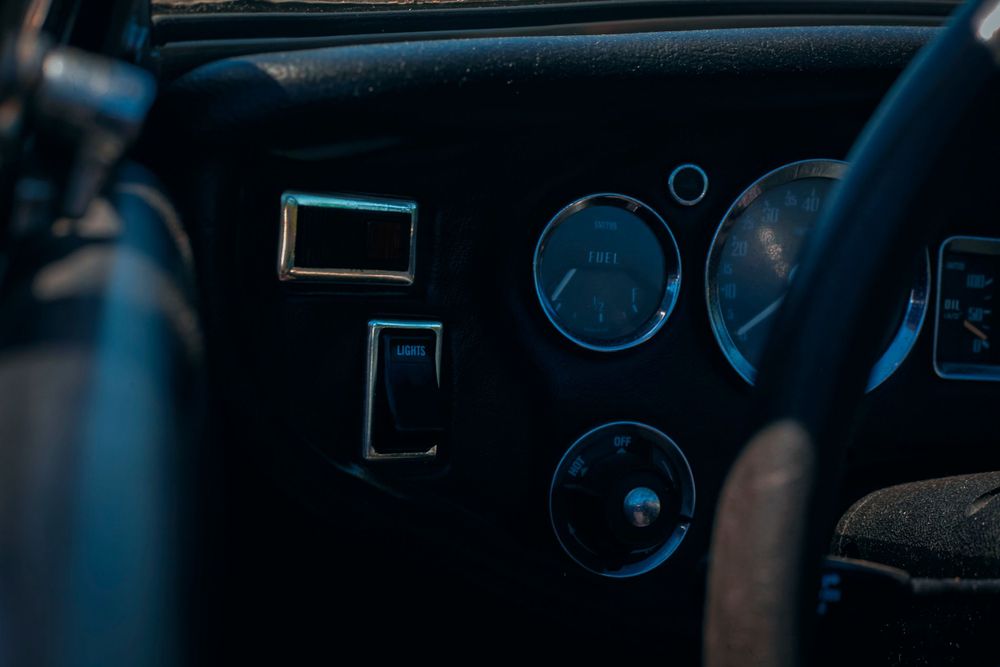 Dark interior shots showing dashboard instruments with blue illumination.