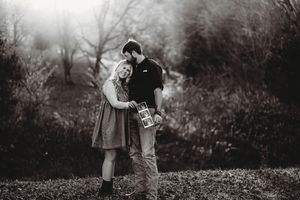Intimate black and white portrait of a couple in a natural outdoor setting.