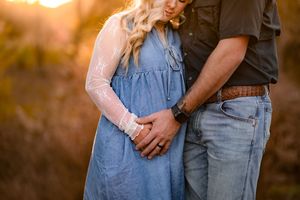 Intimate portrait of a couple in casual clothing during golden hour.