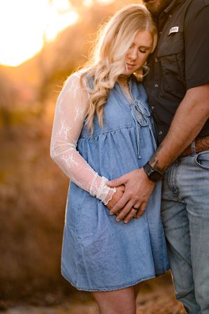 Close-up of a couple in warm sunlight wearing denim and casual attire.