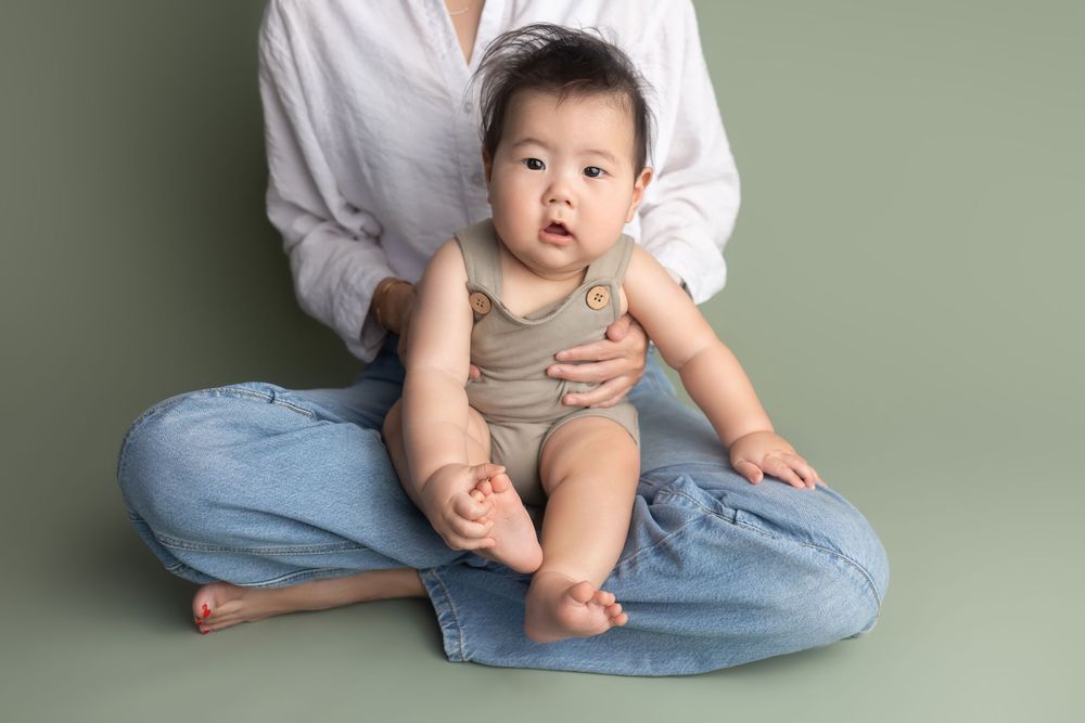 6-month baby boy on  mama's lap, taken by Jen Knightstep, Photographer