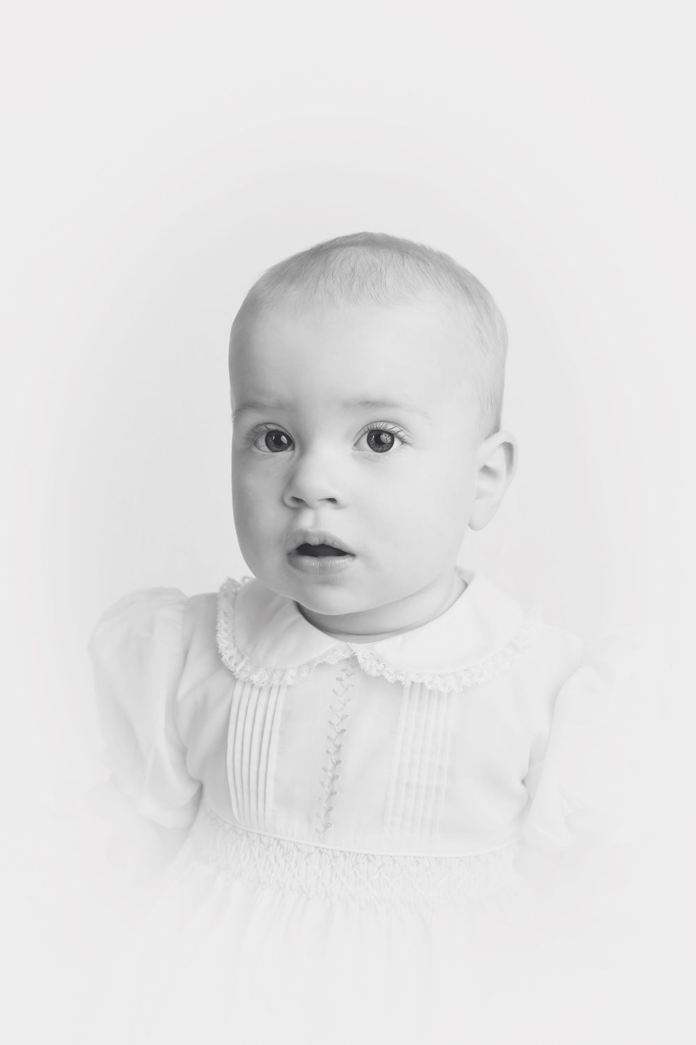 Black and white vignette heirloom style photo of baby girl, taken by Jen Knightstep, Photographer