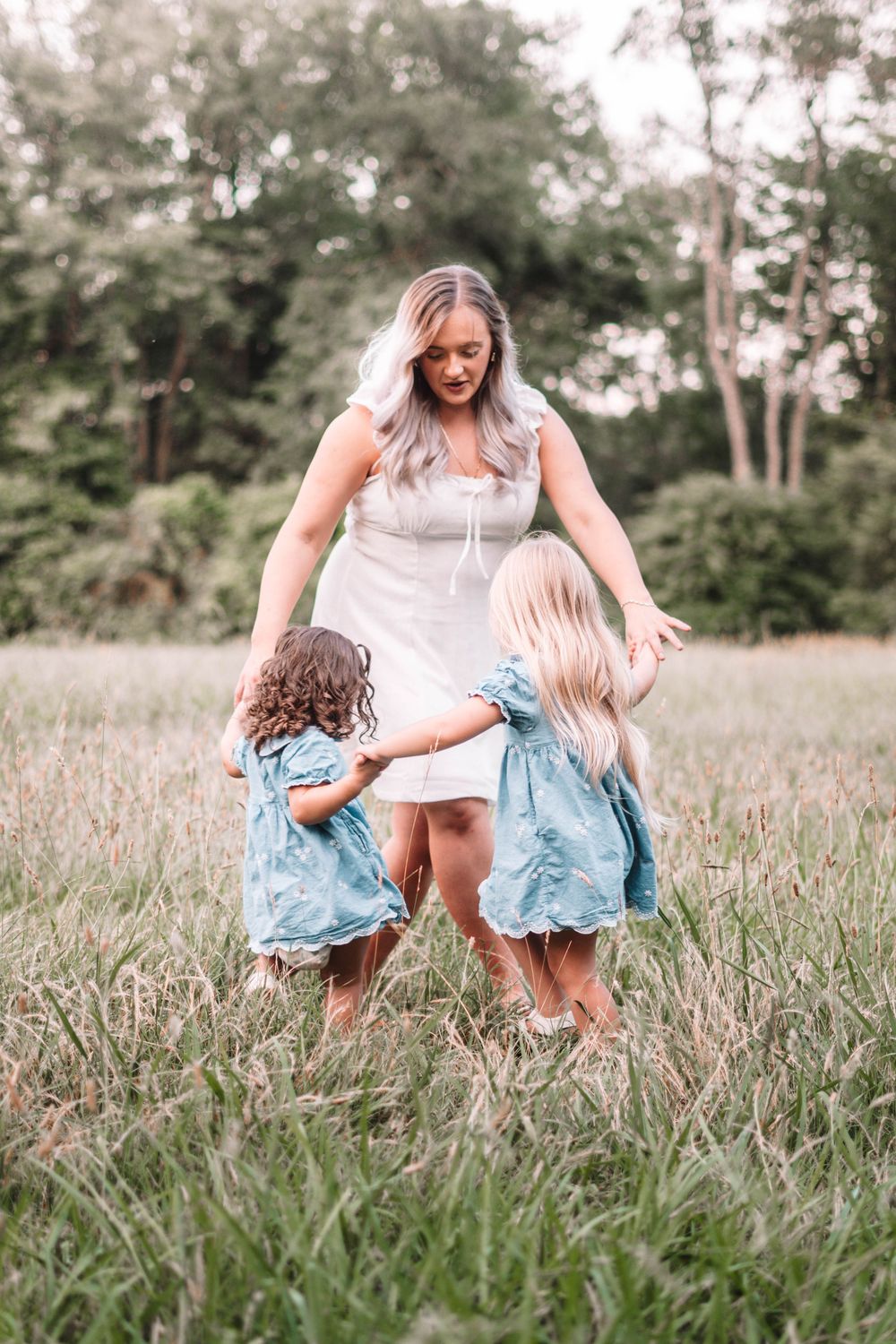 People enjoying a carefree moment together in a grassy summer field.