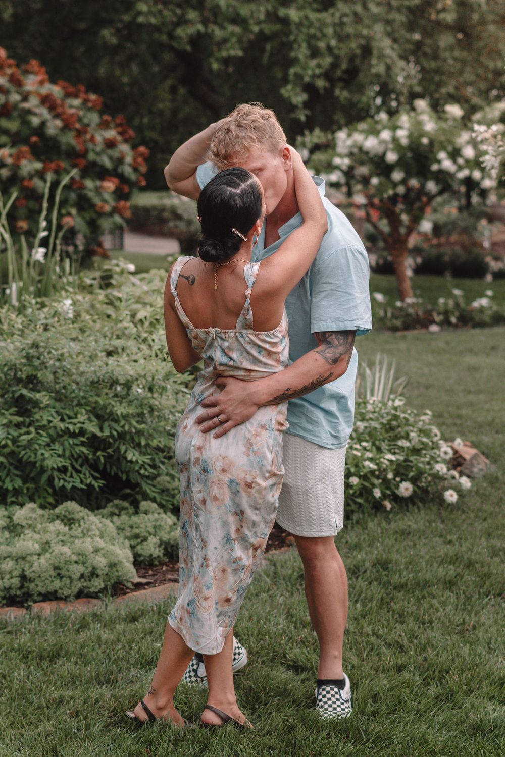 Intimate family portraits captured in lush garden setting during summer.