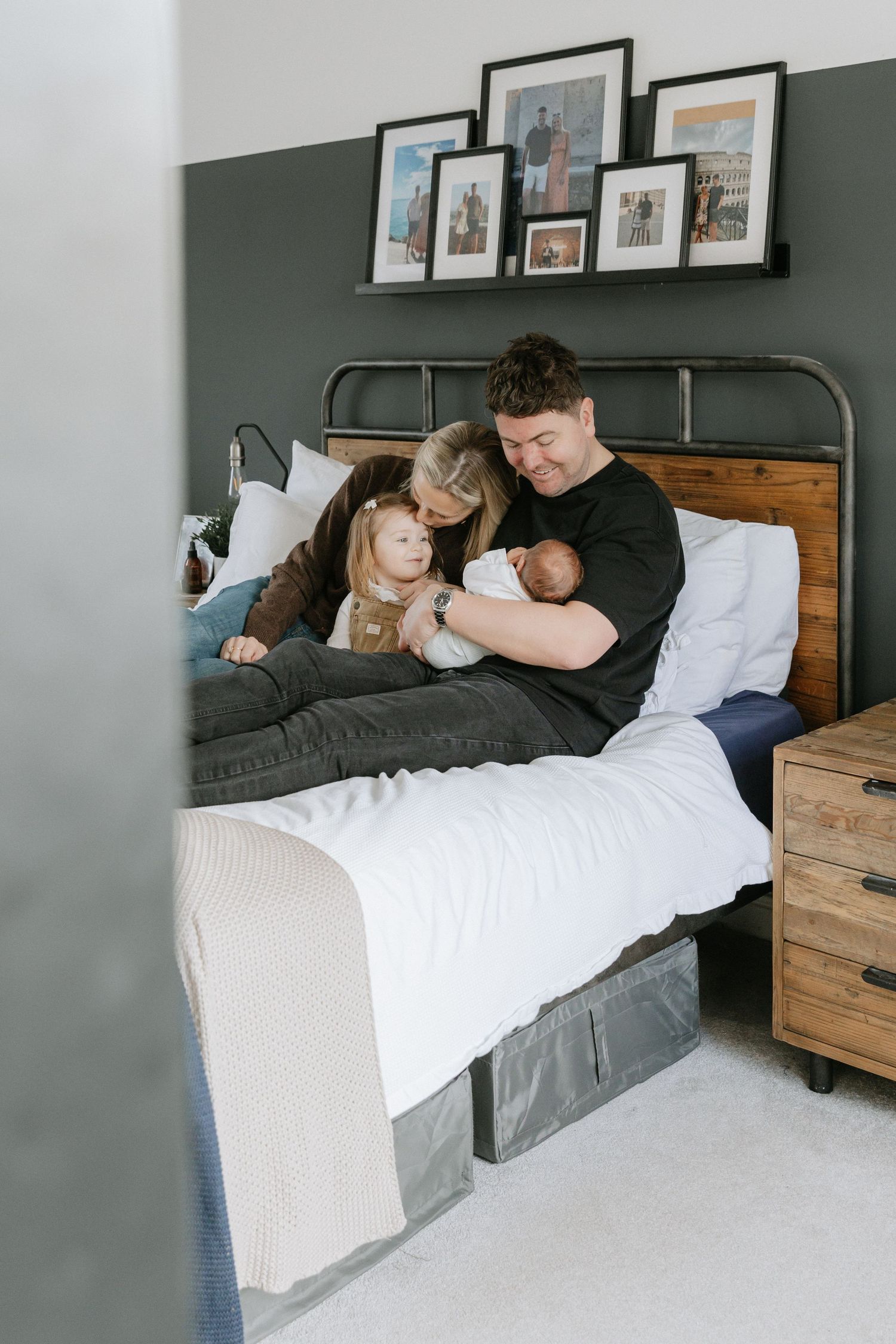 A tender moment shared on a couch with natural light streaming through nearby windows.