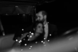 A dreamy blurred romantic moment captured with twinkling lights in the background.