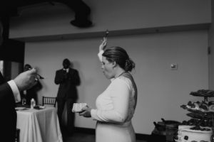 A candid black and white moment captured during a wedding reception.