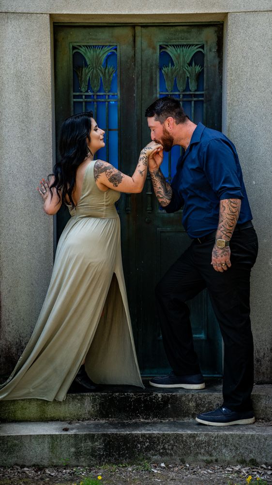 A couple in formal attire poses playfully in front of a vintage doorway for a romantic photo sequence.