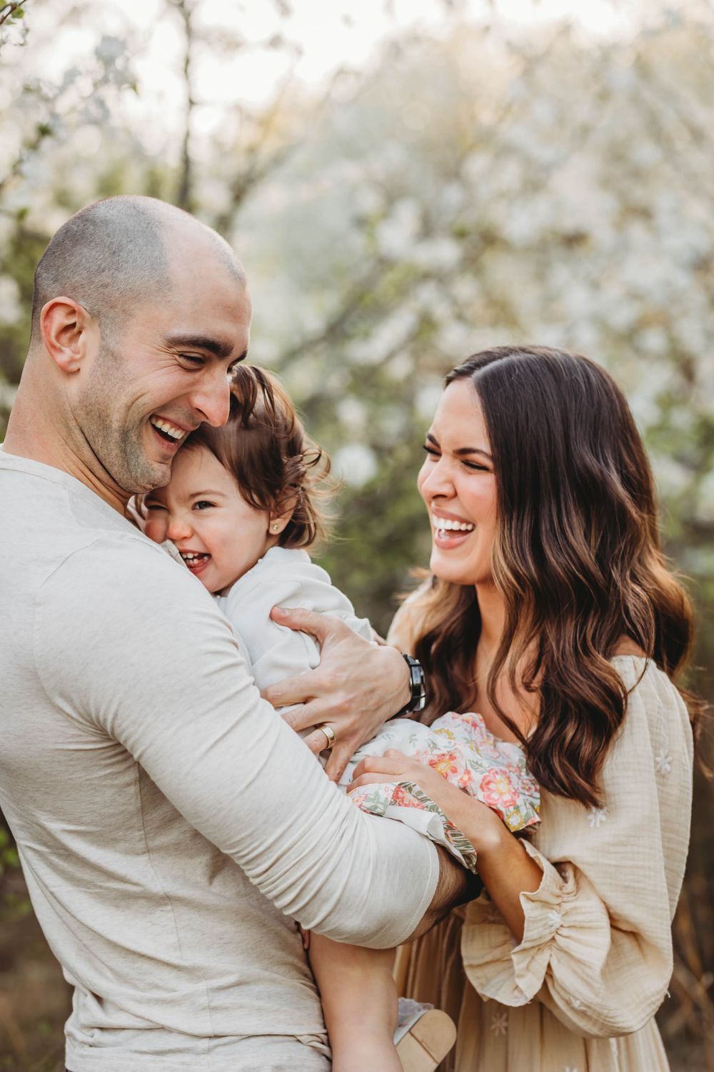Candid family portrait captures genuine laughter and embraces outdoors in Bridgeport, CT.