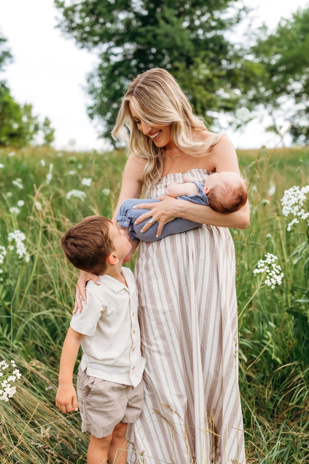 A mother holds her newborn in a field of flowers in New London, CT