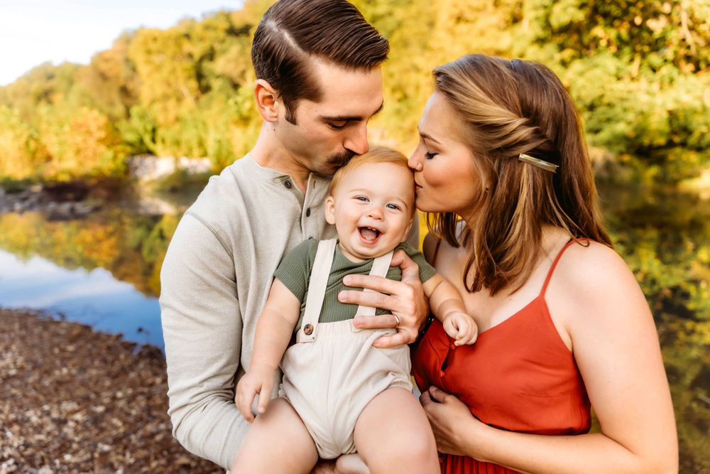 Family shares intimate moments during autumn outdoor photo session with golden lighting in Branford, CT.