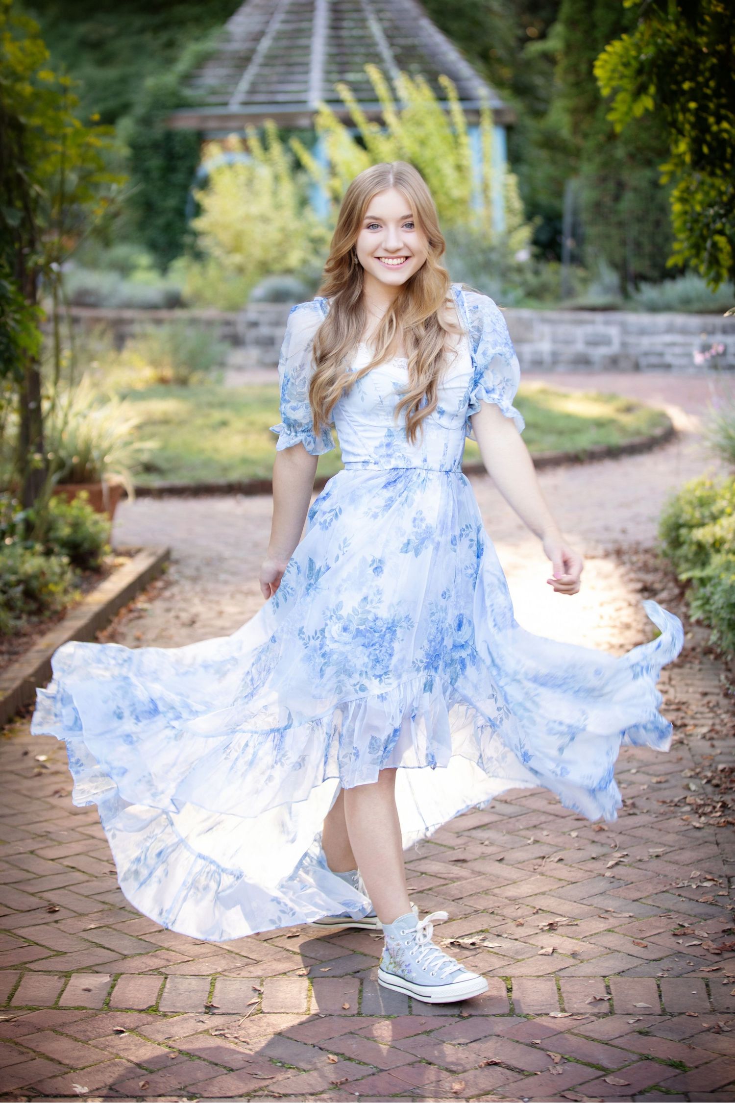 Reynoldsburg senior photos at Inniswood Gardens featuring a flowing blue dress and gorgeous outdoor scenery.
