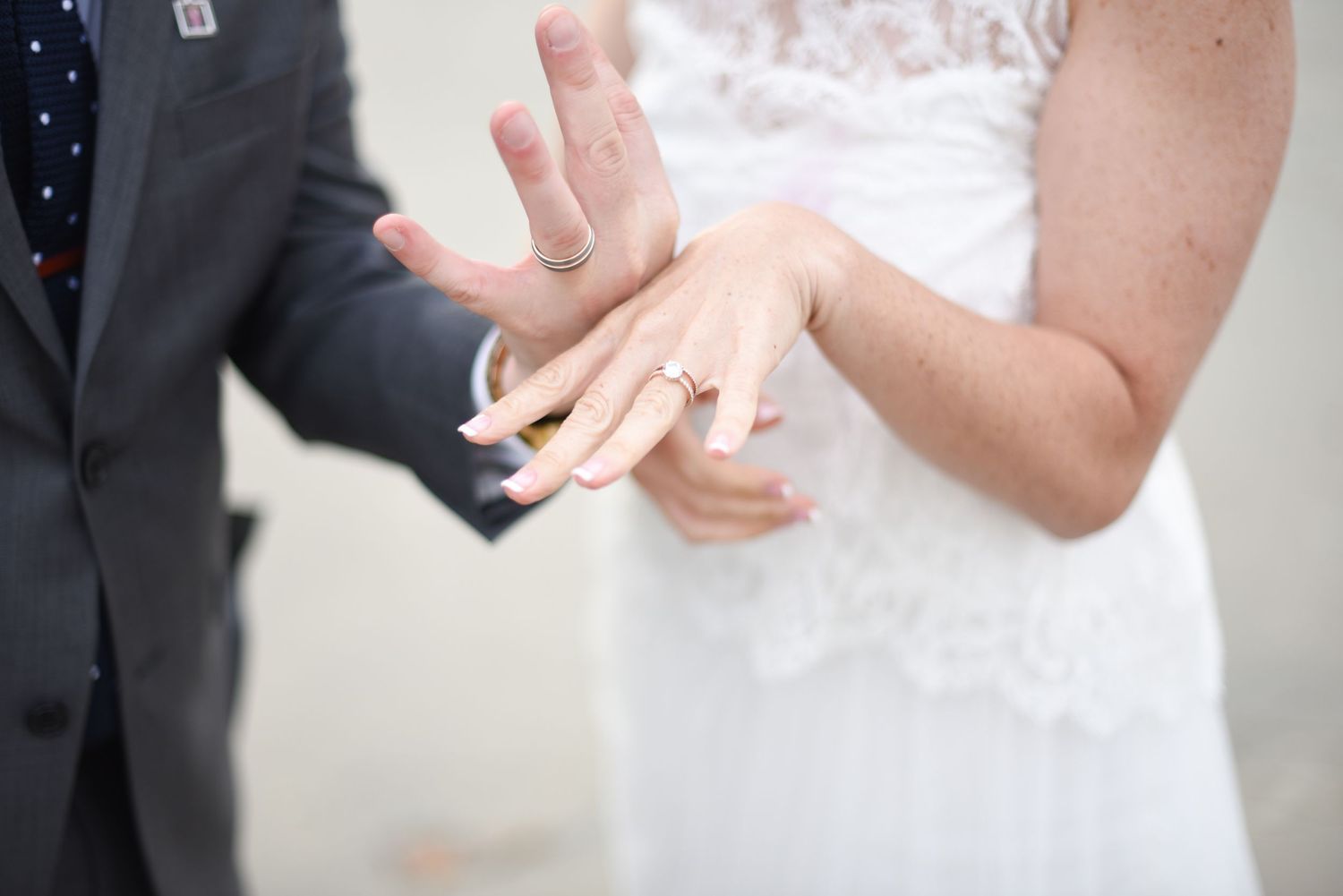 Elegant wedding detail shots focusing on bride and groom's hands with rings.