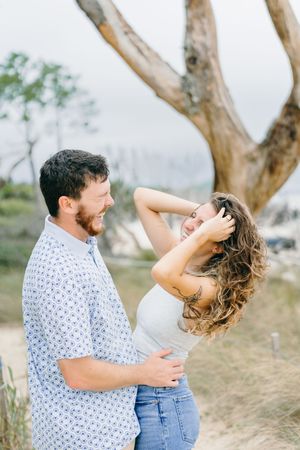 Happy newly engaged couple on near Villas by the Sea during surprise engagement planned by Lindy Rebro Photography