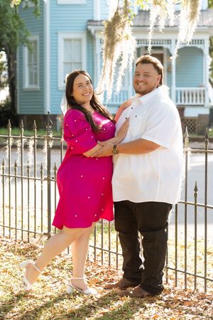 Couple embracing in historical park in Brunswick, Georgia during a portrait engagement session, similar to downtown Savannah