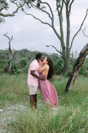 Newly engaged couple celebrating on the Georgia coast at sunset.
